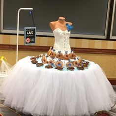 there is a dress made out of doughnuts on the top of a table