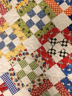 a colorful quilt with many different designs on it