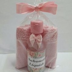 the bottle is wrapped in pink fabric and has a bow on it's neck