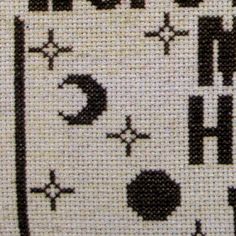 a cross stitch pattern with black and white letters on it's side, including the letter h