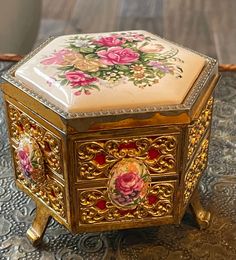 an ornately decorated box sitting on top of a table