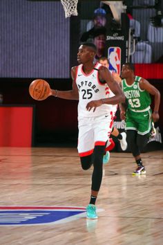 a basketball player dribbling the ball during a game with other players on the court