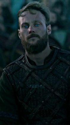 a bearded man with blue eyes in a game of thrones scene, looking at the camera