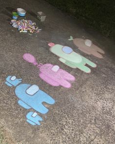 some chalk drawings are on the ground and one is painted pink, blue and green