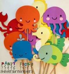 a group of paper cutouts with sea animals on sticks in the shape of octopuses