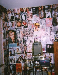 a room with many pictures on the wall and a mirror in front of it,