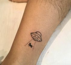 a small tattoo on the arm of a man that has an image of saturn flying through the sky