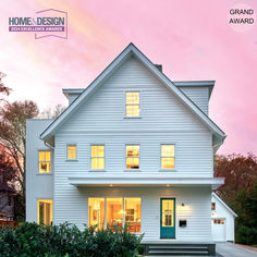 a white house with green front door and steps leading up to the front entrance at dusk