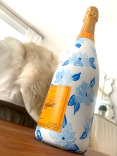 a bottle of champagne sitting on top of a wooden table