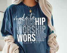 a woman wearing a t - shirt that says worship worship