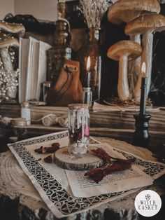 a table topped with candles and napkins next to mushrooms