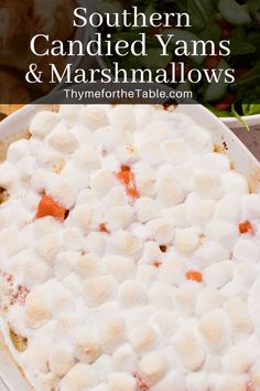 a casserole dish with marshmallows and carrots in the middle