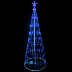 a lighted christmas tree in the dark with stars on it's top and bottom