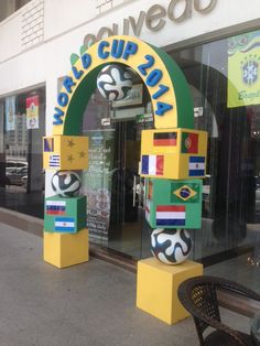 an arch with flags painted on it is in front of a building that says world cup 2012