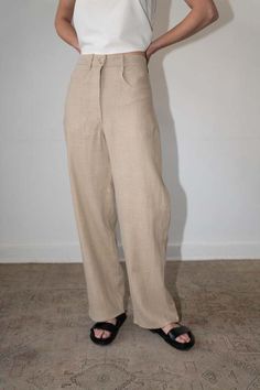 The seba is a sophisticated linen trouser coming to a full long length leg with the a stitching detail in the back similar to our coveted pia denim pant. the seba runs snug but being made with a heavy weight linen the fabric loosens up over time.    - 100% linen (heavy weight)  - button & zipper closer  - model is wearing size s and is 5'10  - made in mexico Tailored Beige Linen Pants, Neutral Straight Leg Bottoms With Welt Pockets, Chic Flax Trousers, Classic Flax Pants For Workwear, Linen Bottoms With Straight Hem For Workwear, Linen Straight Pants For Workwear, Beige Linen Tapered Leg Pants, Straight Linen Pants For Workwear, Beige Tapered Leg Linen Pants