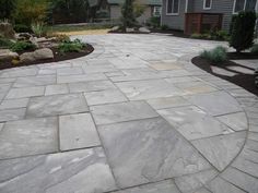 a large stone walkway in front of a house