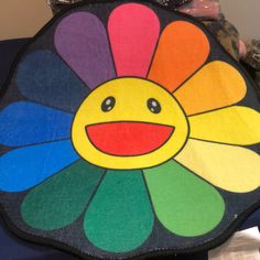 a multicolored flower shaped pillow sitting on top of a table