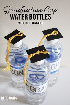 three water bottles with graduation caps on top and the words congratulations cup written in gold