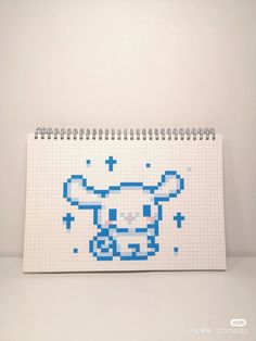 a notebook with a pixellated image of a cow