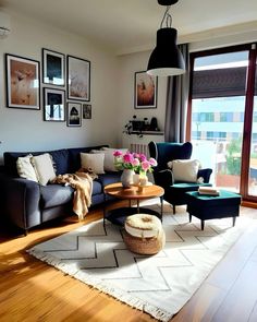 a living room filled with furniture and pictures on the wall