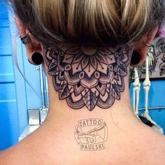 a woman with a tattoo on her neck and behind the neck is an intricate design