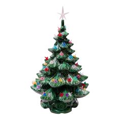 a ceramic christmas tree with ornaments on it and a star hanging from the top, in front of a white background