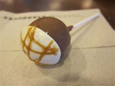 a chocolate covered candy with caramel drizzled on it's side