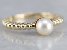 The perfect gift for a Sweet Sixteen or a June Birthday, this simple solitaire would look well stacked with other rings or bands, as well. Versatile and lovely, this will be a perfect wardrobe basic for years to come. Metal: 14K Yellow Gold Gem: Pearl Gem Measurements: 5.7 mm, Round Ring Size: 5.75 Marks: "14KT" Stamped on the inside band Fine Jewelry Stackable Pearl Ring With Round Band, Elegant 14k Gold Stackable Pearl Ring, Stackable White Gold Pearl Ring With Round Band, Elegant Stackable Yellow Gold Pearl Ring, Stackable Pearl Ring In White Gold With Round Band, Elegant Stackable Pearl Ring In Yellow Gold, Elegant Yellow Gold Stackable Pearl Ring, Classic Yellow Gold Pearl Ring With Round Band, Classic Stackable Pearl Ring