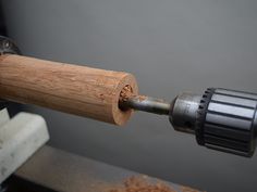 a drill is being used to fix a piece of wood