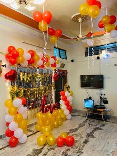 balloons and streamers are hanging from the ceiling in this party room with marble flooring