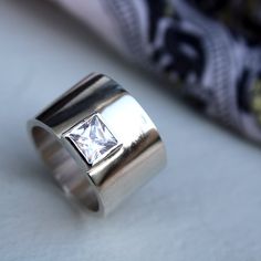 if i ever get engaged... please direct my significant other to this design for a ring.... http://www.etsy.com/listing/74523119/chic-statement-ring-by-lolaandcash Modern Wide Band Ring With Tension Setting For Anniversary, Modern Diamond Ring With Thick Band, Modern Square Cut Ring With Vs Clarity, Modern Square Cut Diamond Ring, Modern Wide Band Ring For Wedding, Modern Wide Band Diamond Ring, Modern Jewelry With Solitaire On Wide Band, Modern Silver Wide Band Diamond Ring, Modern Silver Diamond Ring With Wide Band