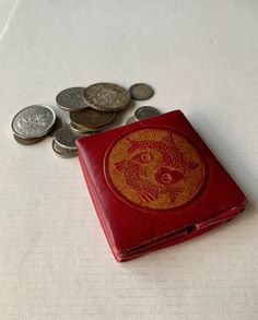 This accordion style vintage coin pouch is from the 1960s. It would make a terrific gift for the fisher or man in your life.  **NO COINS ARE INCLUDED. THEY ARE PICTURED FOR DEMONSTRATION ONLY.** Features:  * This wallet is pre-owned and has slight wear due to age and use.  * Beautiful aged red and orange with fish motif.  * Made of leather.  * Snap closure. * Approximately 3" square.  * Measure approximately 3/8" high when folded.  * Free shipping on orders over $35. Combine orders to receive free shipping.  Don't miss out on this unique vintage item! Retro Rectangular Wallet With Coin Pocket, Retro Pouch Coin Purse, Vintage Wallet With Coin Pocket, Vintage Wallets With Coin Pocket For Everyday, Retro Bifold Wallet As Gift, Handmade Vintage Compact Coin Purse, Vintage Compact Wallet, Vintage Red Bifold Wallet, Retro Bifold Wallet As A Gift