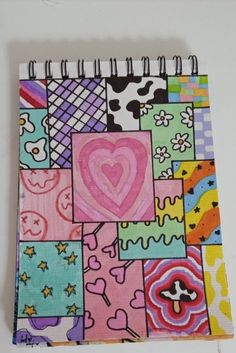 a colorful notebook covered in lots of different colored images and hearts on it's cover