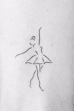 a ballerina tattoo on the back of a woman's arm