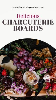 the cover of delicious charcuterie boards is shown with grapes, cucumbers and cheeses