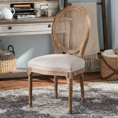 a chair sitting on top of a rug in front of a desk with a basket