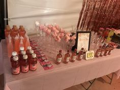 the table is set up with many different condiments and bottles on it,