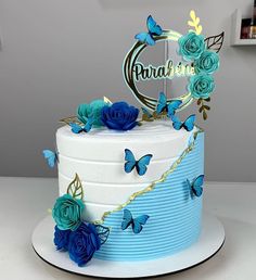 there is a cake with blue flowers on it and butterflies around the top that say congratulations