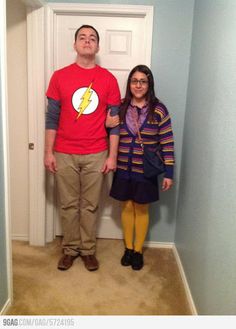 a man and woman standing in front of a door with the flash symbol on it