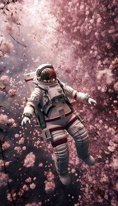 an astronaut floating in the water surrounded by pink flowers