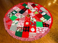 a red and green patchwork table top on a wooden floor