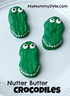 three cookies decorated to look like alligators with googly eyes on them and the words, nutter butter crocodileies