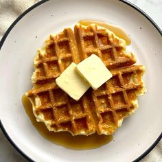 waffles with butter and syrup on a white plate