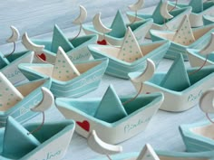 small paper boats are lined up on the table