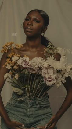 a woman is holding flowers in her stomach