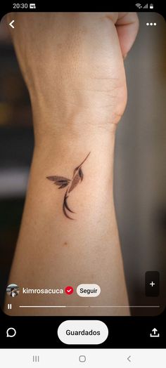 a small bird tattoo on the side of a woman's right arm and wrist