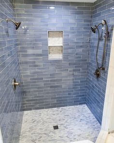 a walk in shower sitting next to a tiled wall and white flooring on the walls