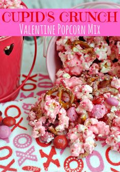 valentine's popcorn mix in a red bucket with the words cupid's crunch on it