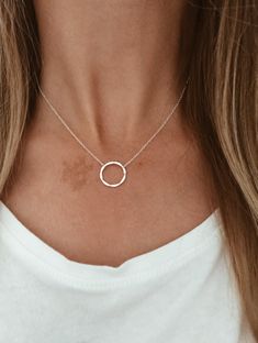 "This is a beautiful and delicate necklace that has a hammered sterling silver ring in the middle of a sterling silver chain. Or a hammered 14k gold fill ring in the center of a 14k gold fill chain. This necklace is perfect for layering or can be worn alone as it is shown here.  Pictured:  1st two pictures - 16\" 2nd picture - 18\" Matching Bracelet: https://www.etsy.com/listing/240465287/hammered-infinity-circle-in-1420-gold?ref=shop_home_active_10" Simple Silver Necklace, Hammered Sterling Silver, Gold Filled Ring, Matching Bracelet, Circle Necklace, Hammered Silver, Matching Bracelets, Delicate Necklace, Necklace Designs