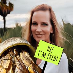 a woman holding a sign that says hi i'm fried